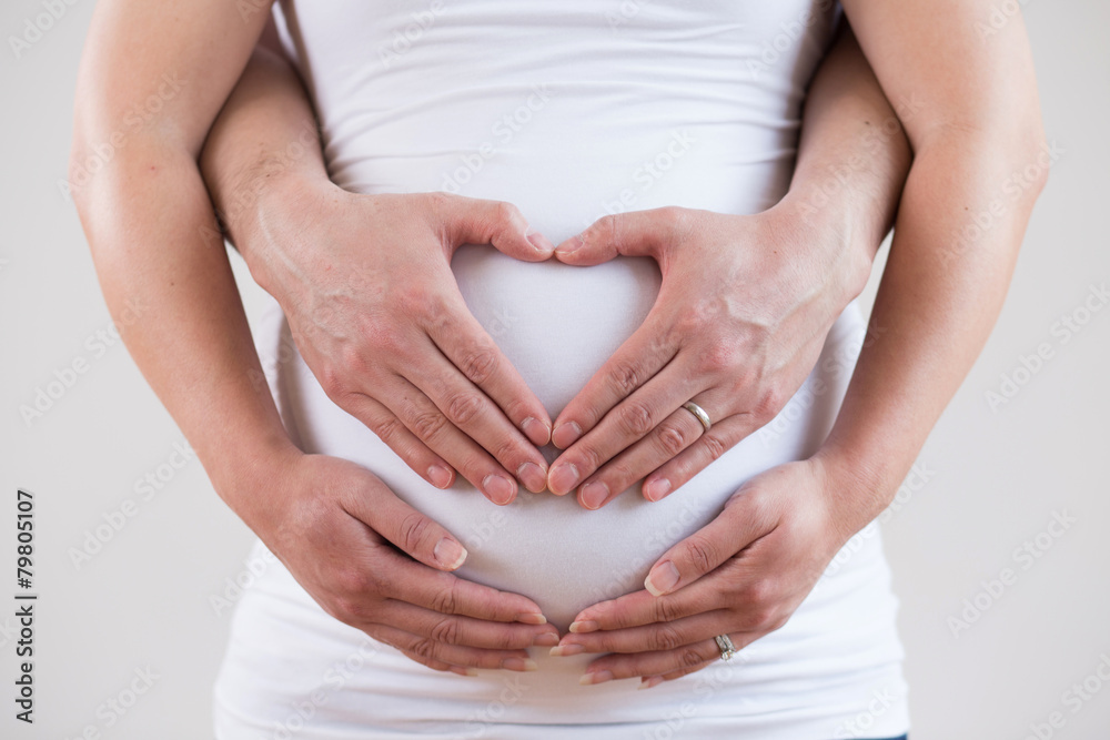 Heart Shaped Hands of Pregnant Woman and Her Husband Heart Shaped Hands of Pregnant Woman and Her Husband