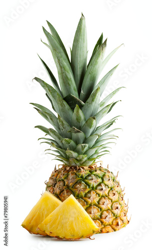 Half pineapple with leaves and cut pieces