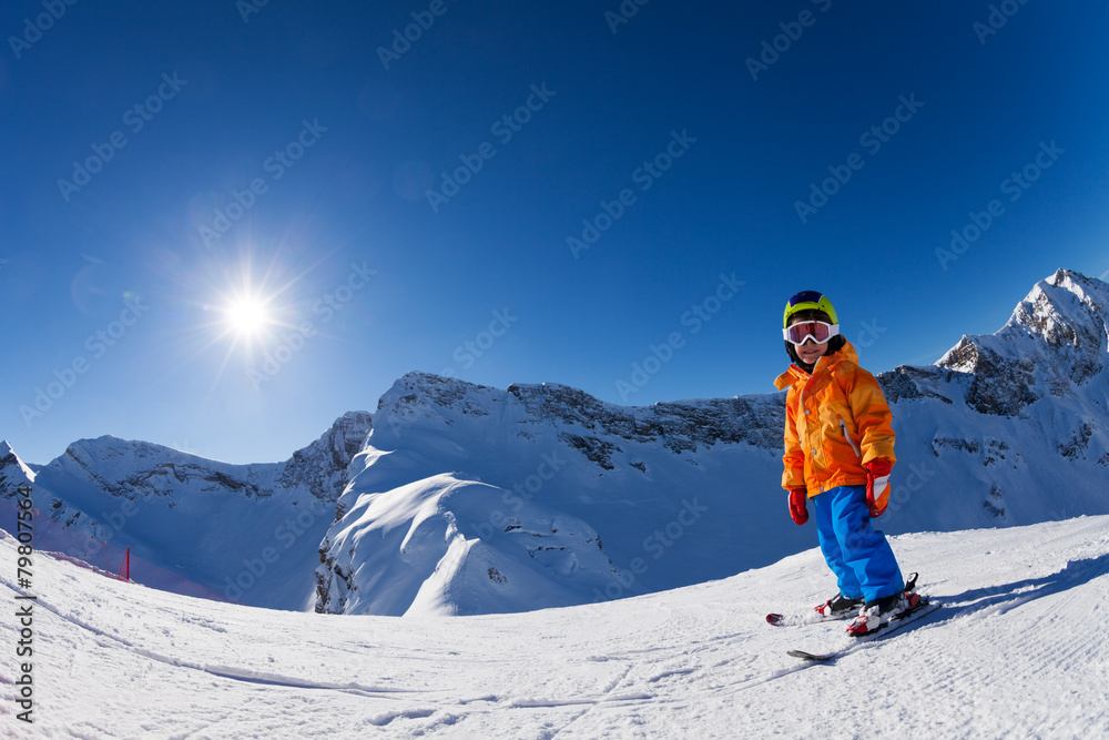 Fisheye view of boy skiing on mountain slope