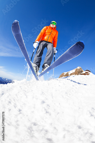 Skier jumping view from below during winter day photo