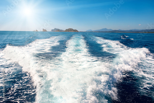 Waves on blue sea behind the boat Fototapet