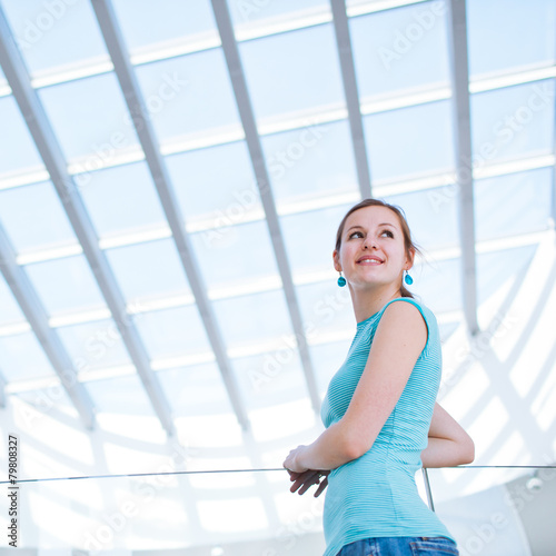 Free Download Pretty, young woman using her mobile phone/speaking on the phone - GFXLoad