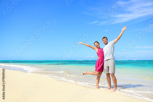 Freedom on beach vacation - happy carefree couple