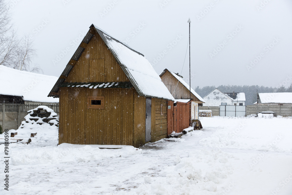 wooden constructions under snow