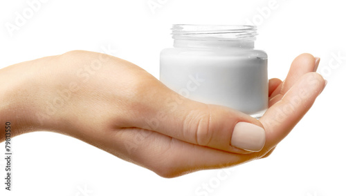 Female hand holding jar of cream isolated on white