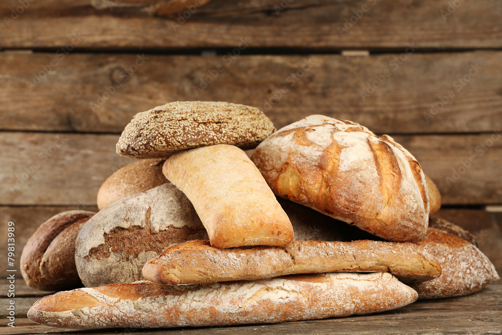 Different fresh bread on old wooden table Different fresh bread on old wooden table
