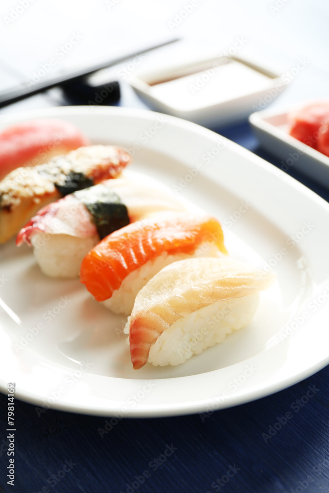 Sushi on plate on wooden table background Sushi on plate on wooden table background