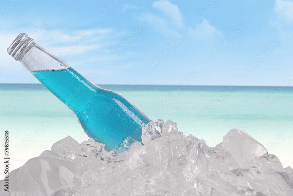 Beer bottle on ice cube at beach Beer bottle on ice cube at beach
