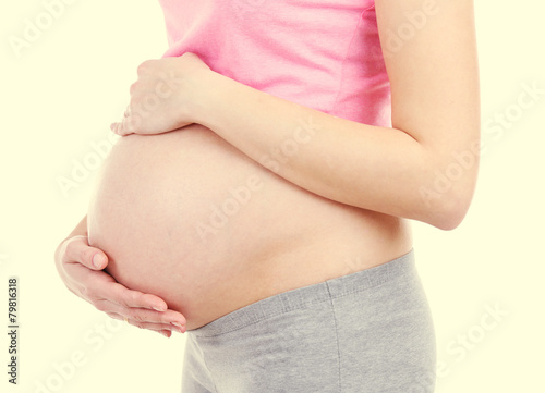 Beautiful young pregnant woman touching her belly © Africa Studio