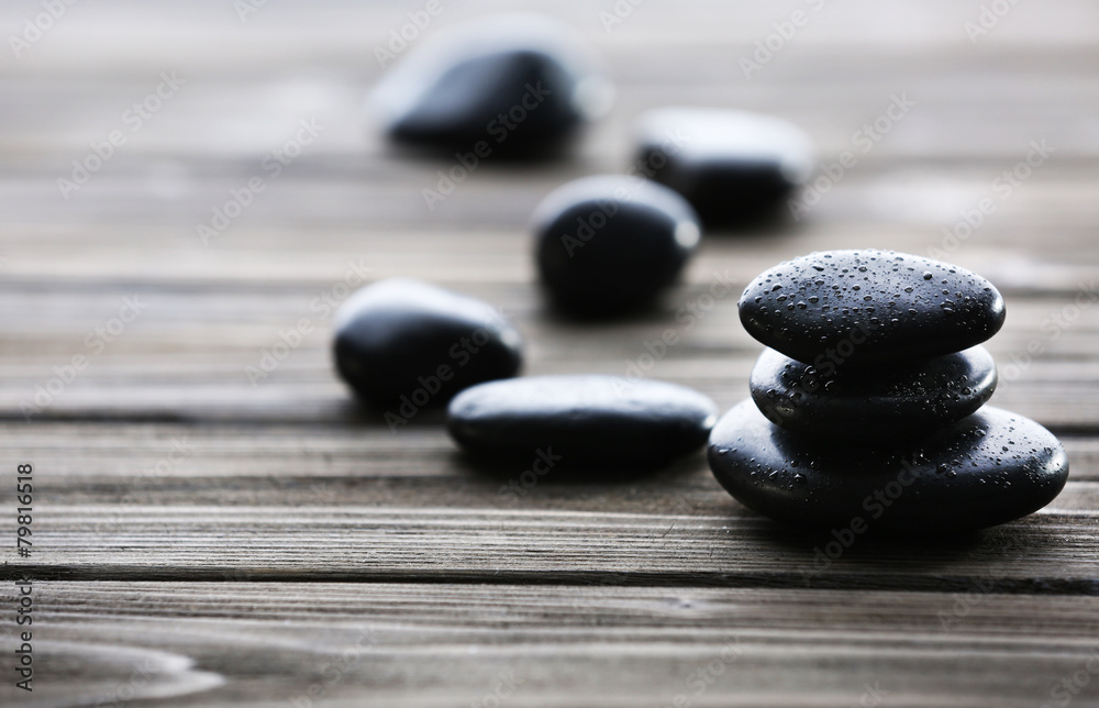 Spa stones with water drops on wooden background Spa stones with water drops on wooden background