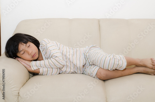 Asian girl sleeping on sofa at home.