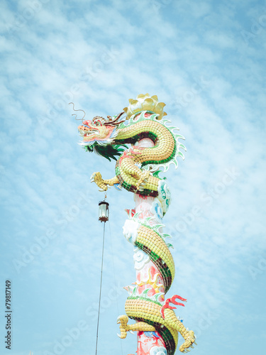 Dragon statue on red pillar in Chinese temple