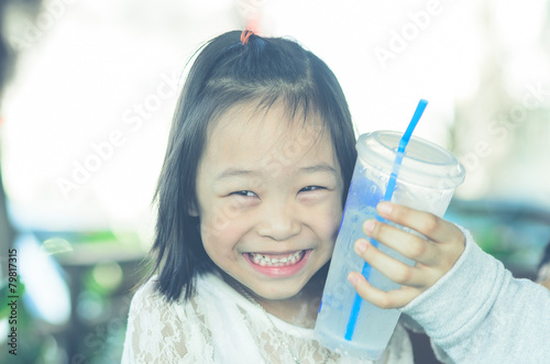 Portrait of Asian girl and cool drink on face.
