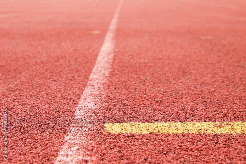 Yellow lines of running red rubber racetracks in stadium Yellow lines of running red rubber racetracks in stadium