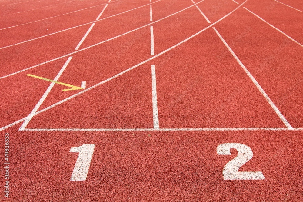 White track number on red racetrack, running outdoor stadium