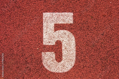 White number on red rubber racetrack running stadium