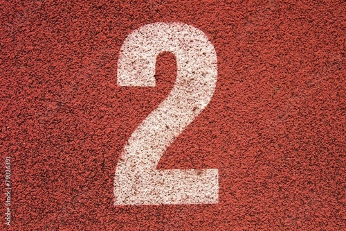 White track number on red rubber racetrack