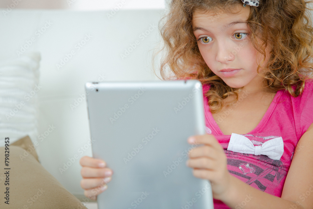 Little girl using a tablet computer Little girl using a tablet computer