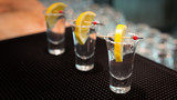 Three tequila shots with lemon