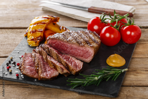 grilled beef steak rare sliced with vegetables