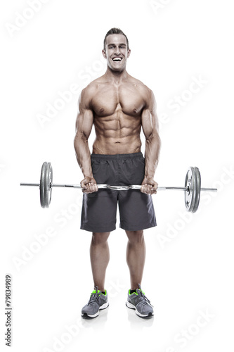 Muscular bodybuilder guy doing exercises with dumbbells over whi