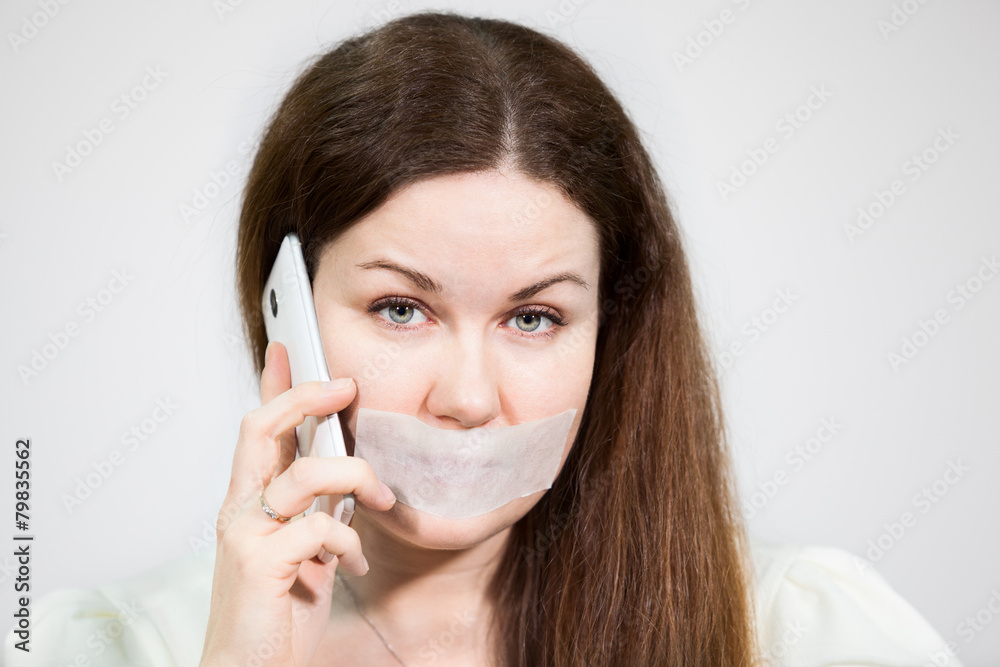 Caucasian woman with sad eyes and mouth sealed call mobile Caucasian woman with sad eyes and mouth sealed call mobile