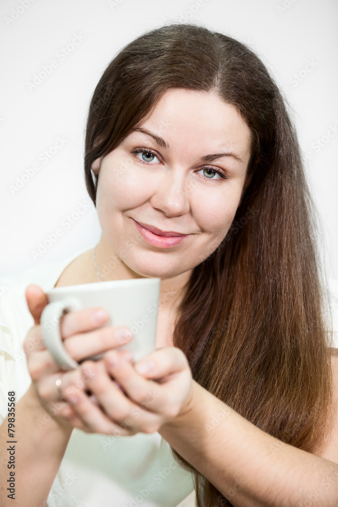 Caucasian happy smile woman holds tea mug in hands, background Caucasian happy smile woman holds tea mug in hands, background