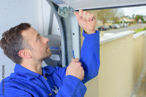 Man installing a garage door