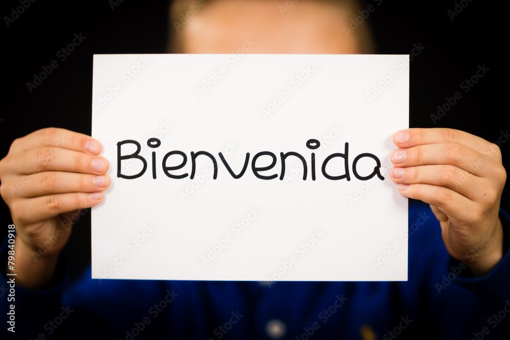 Child holding sign with Spanish word Bienvenida - Welcome Child holding sign with Spanish word Bienvenida - Welcome