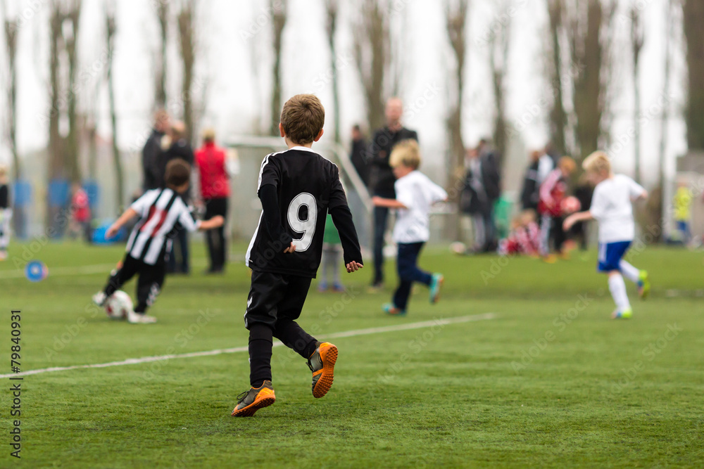 Two teams of boys playing soccer