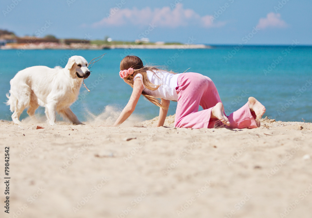 Girl are playing with her don on a beach Girl are playing with her don on a beach