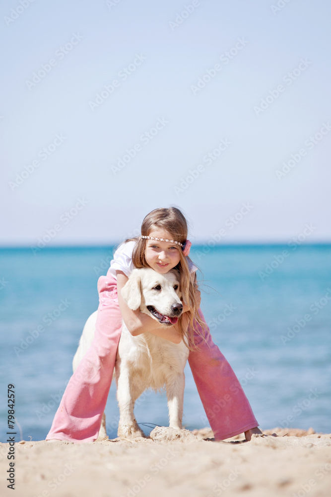 Girl are playing with her don on a beach Girl are playing with her don on a beach