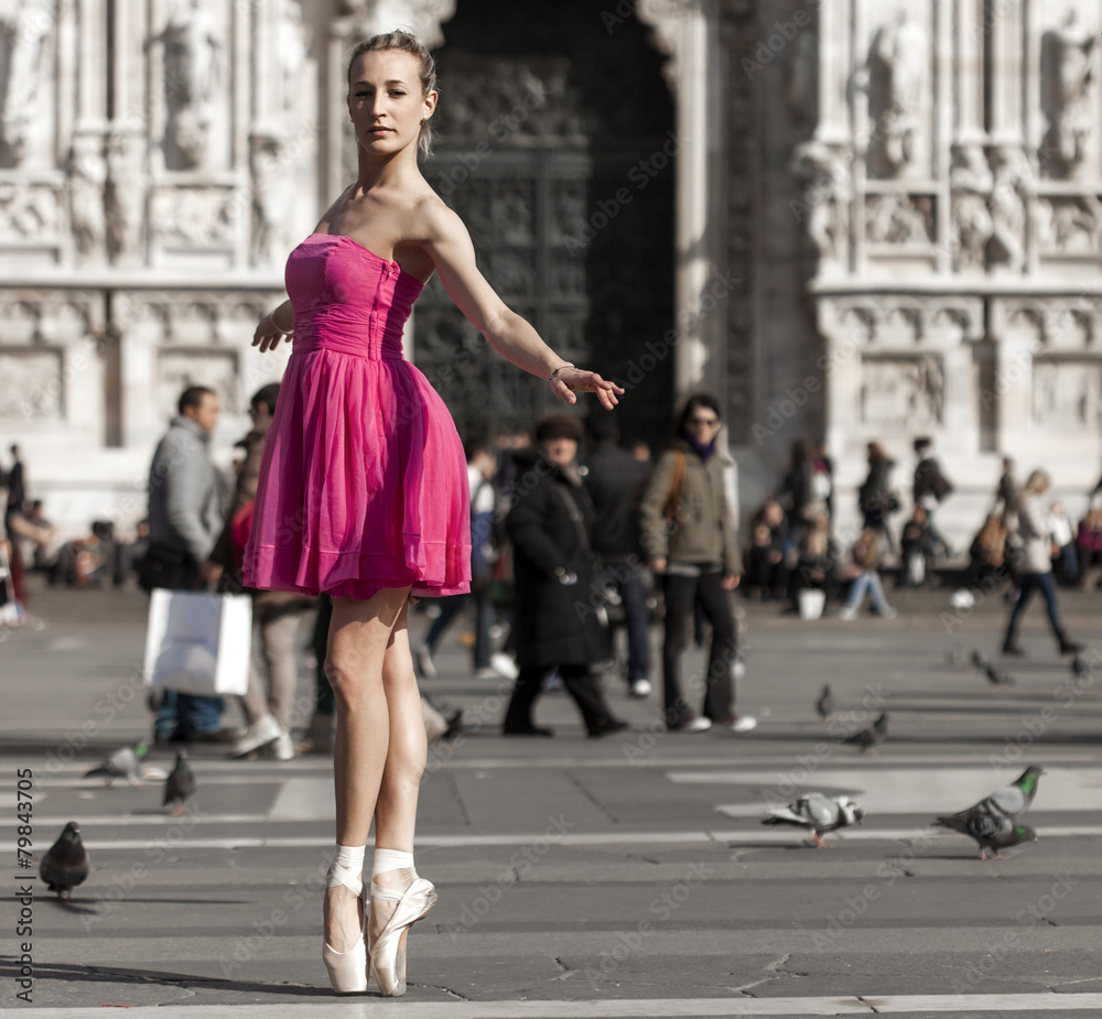Girl dancing near Milan Cathedral Square and looking