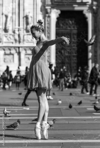 Girl dancing near Milan Cathedral Square black and white