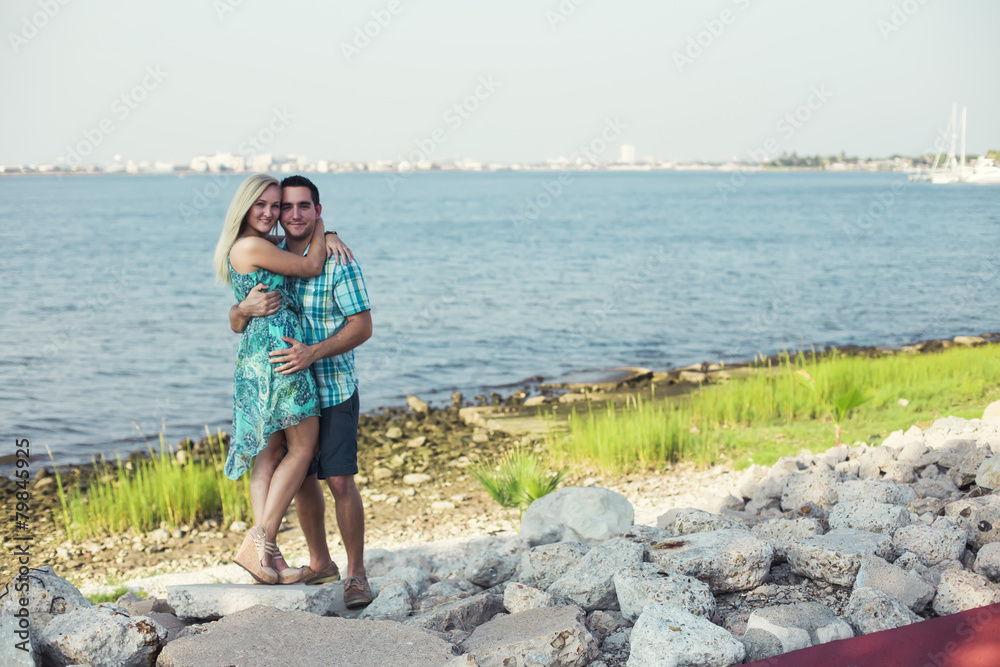 man hugged the girl standing by the river