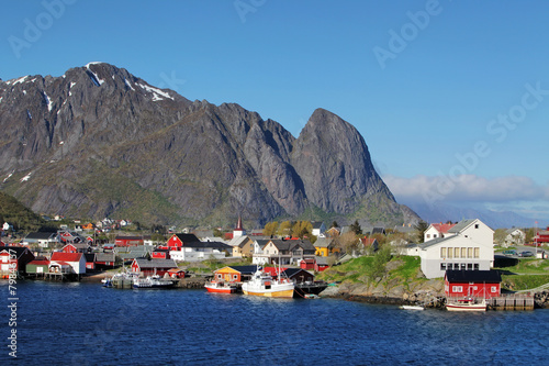 Norwegian fishing village with traditional red rorbu huts, Reine photo