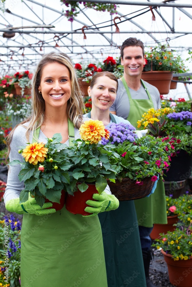Florist working with flowers in greenhouse.