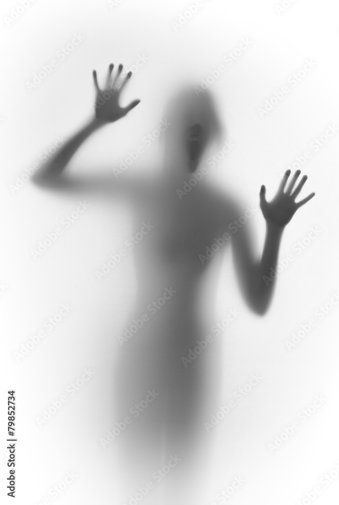 Shouting scary face and body silhouette behind a glass surface