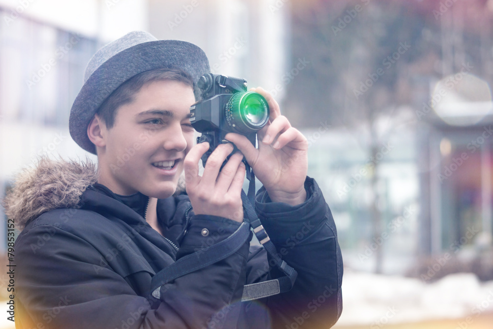 Young Man looking through Viewfinder of an old Camera Young Man looking through Viewfinder of an old Camera
