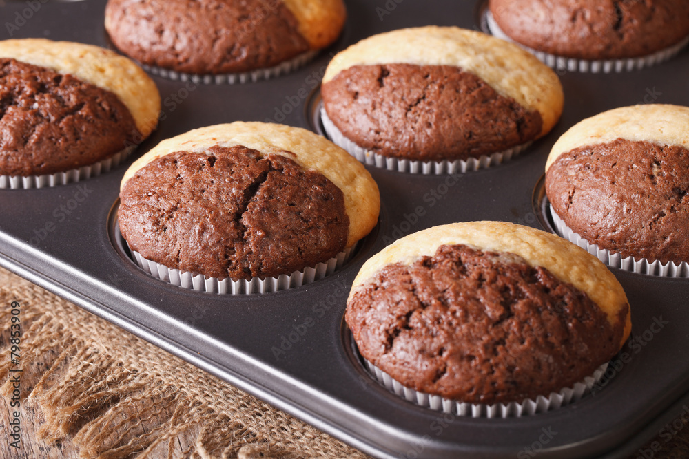 chocolate muffins in baking dish from the oven macro. Horizontal