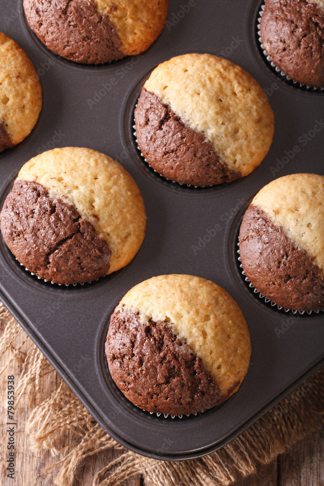 beautiful muffins in baking dish closeup, vertical top view beautiful muffins in baking dish closeup, vertical top view