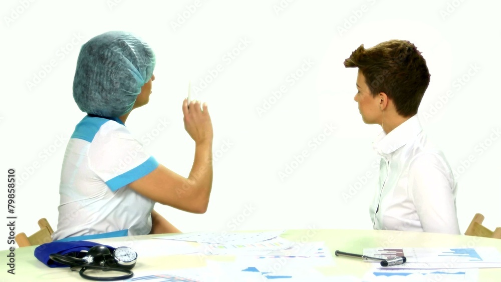 Female doctor explaining diagnosis to her female patient on Female doctor explaining diagnosis to her female patient on