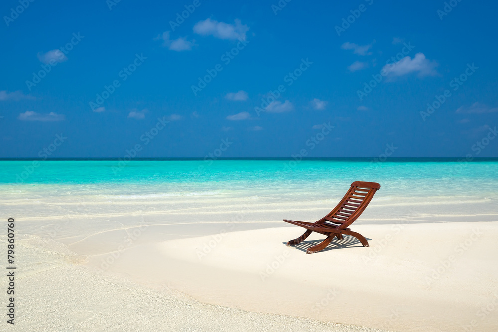 Beach lounger on sand beach.