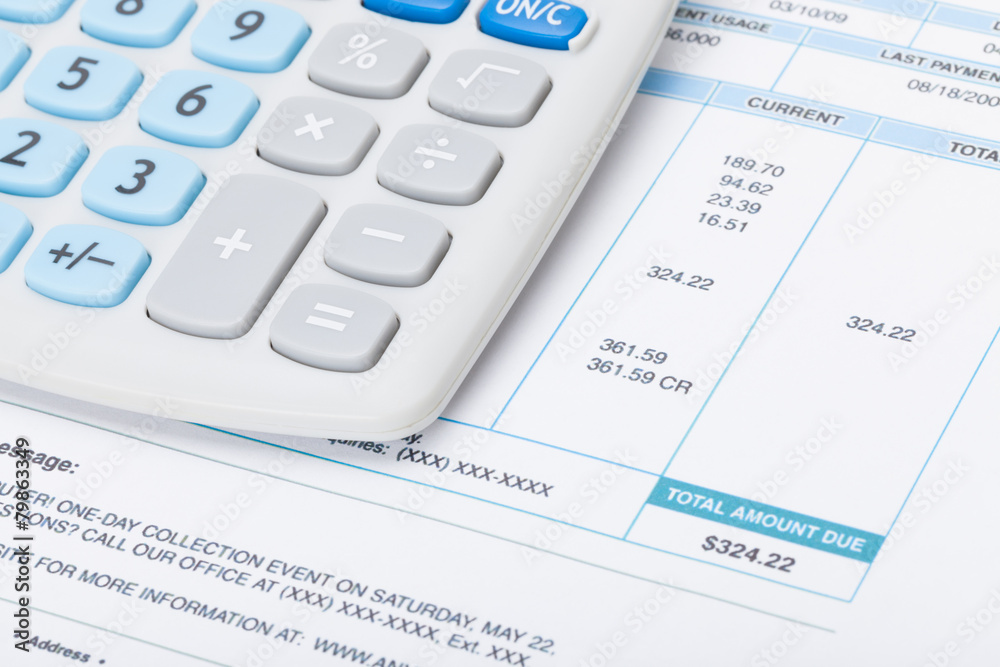 Neat calculator with utility bill under it Neat calculator with utility bill under it