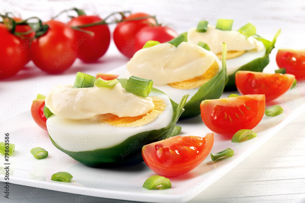 Easter eggs with mayonnaise and spring onions and cherry tomatoe Easter eggs with mayonnaise and spring onions and cherry tomatoe