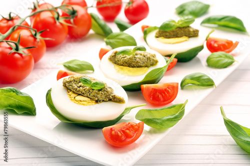 Easter eggs with pesto and cherry tomatoes