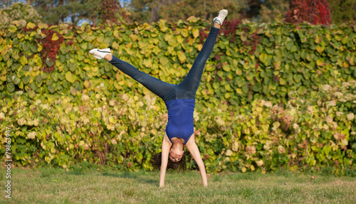 Sporty woman show cartwheel