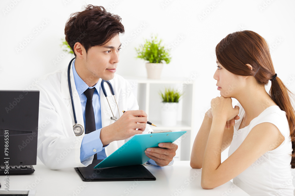 doctor talking with female patient in office doctor talking with female patient in office