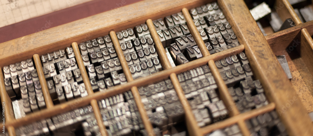 Close-up of metal letterpress letters in printing machine Close-up of metal letterpress letters in printing machine