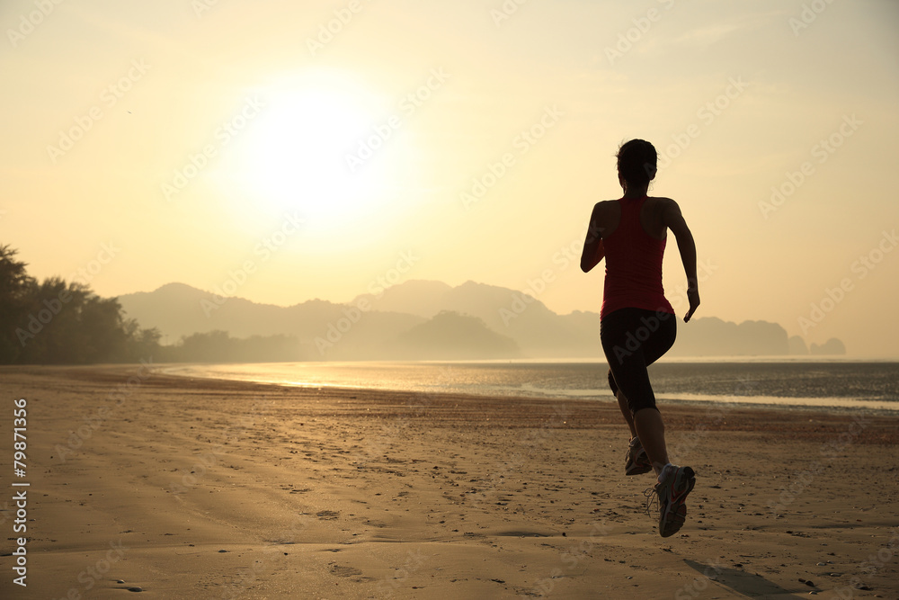 	young healthy lifestyle woman running at sunrise beach